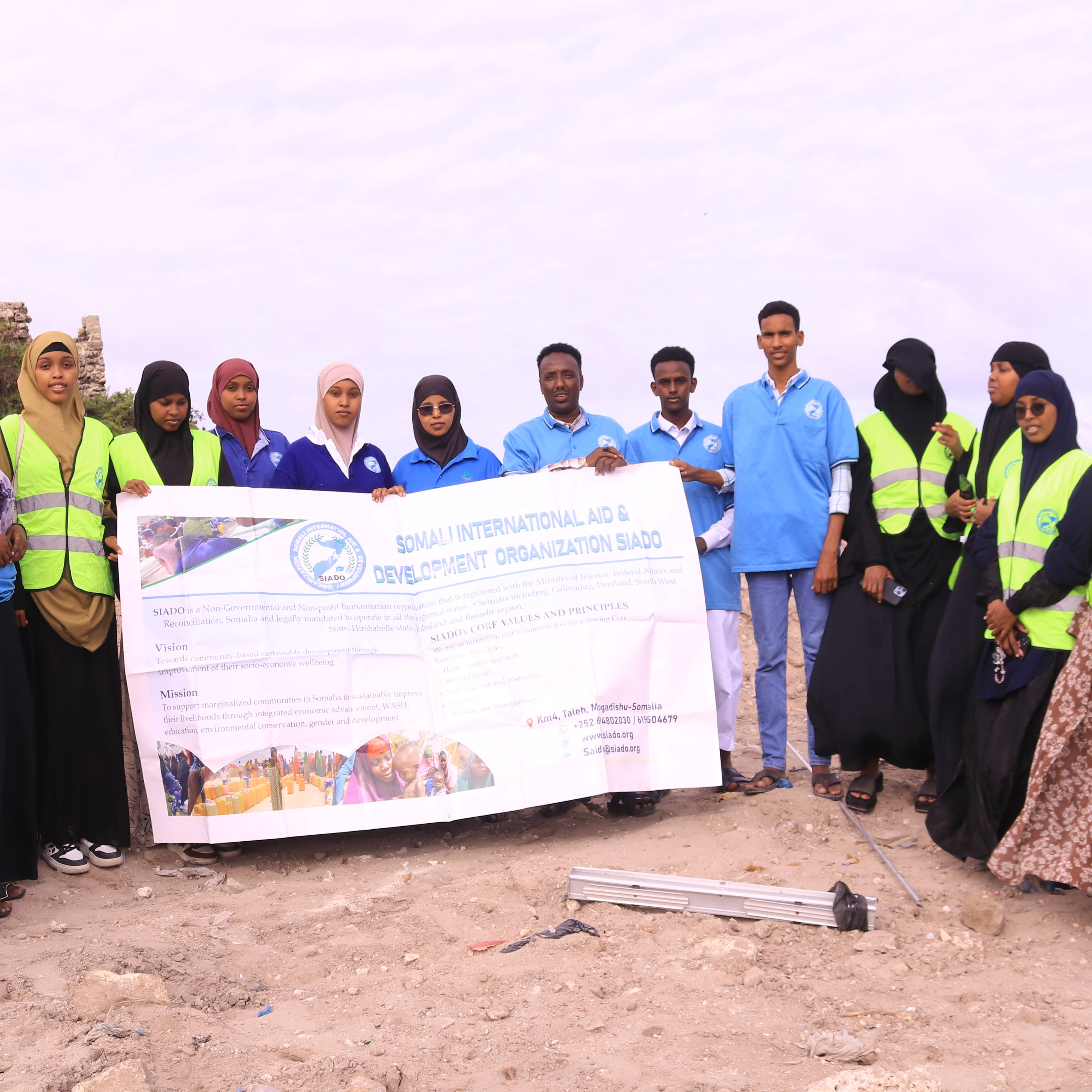 SIADO-provided photograph of a field team holding an organization banner.